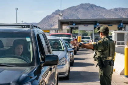 Border Wait Times sign above vehicle lanes at a land crossing
